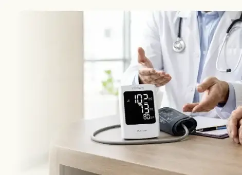A Paloma clinician discussing a connected blood pressure monitor with a patient